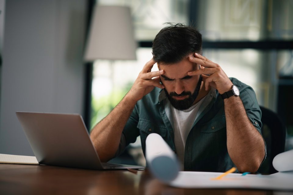 worried man looking at finances