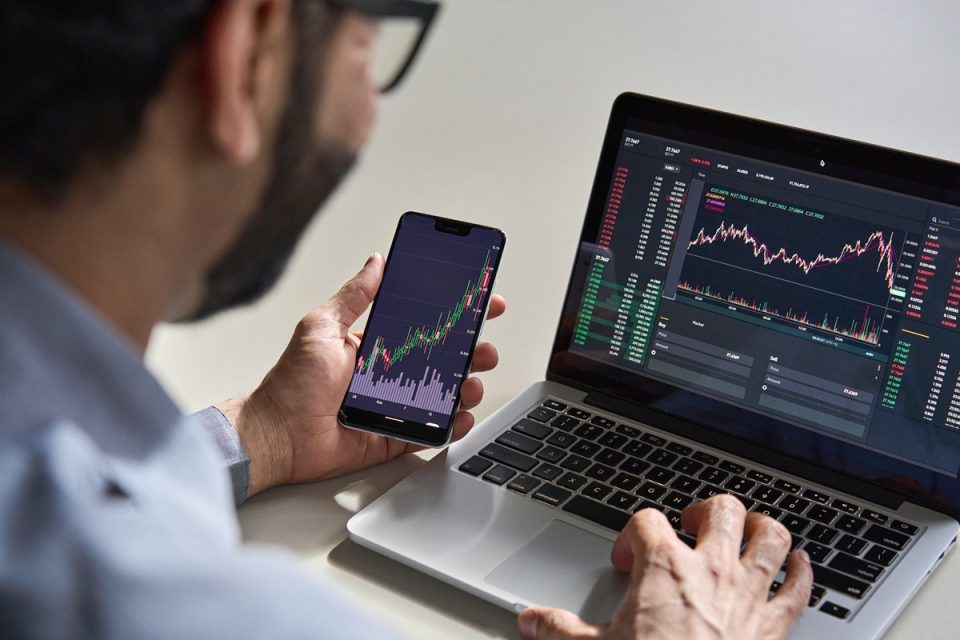 Investor looking at screens